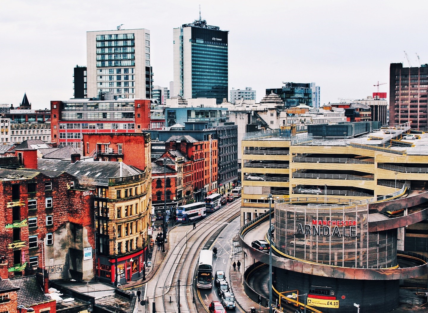 Image description: A view showing busy Manchester city streets taken from above. Photo by Jeremy Bishop on Unsplash